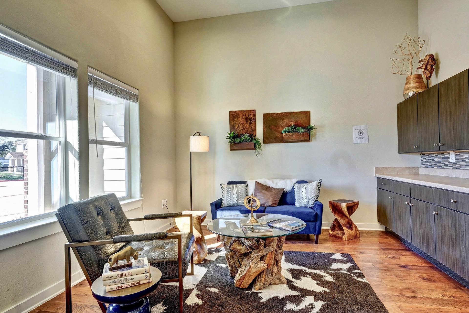a living room with a couch and a table and a window